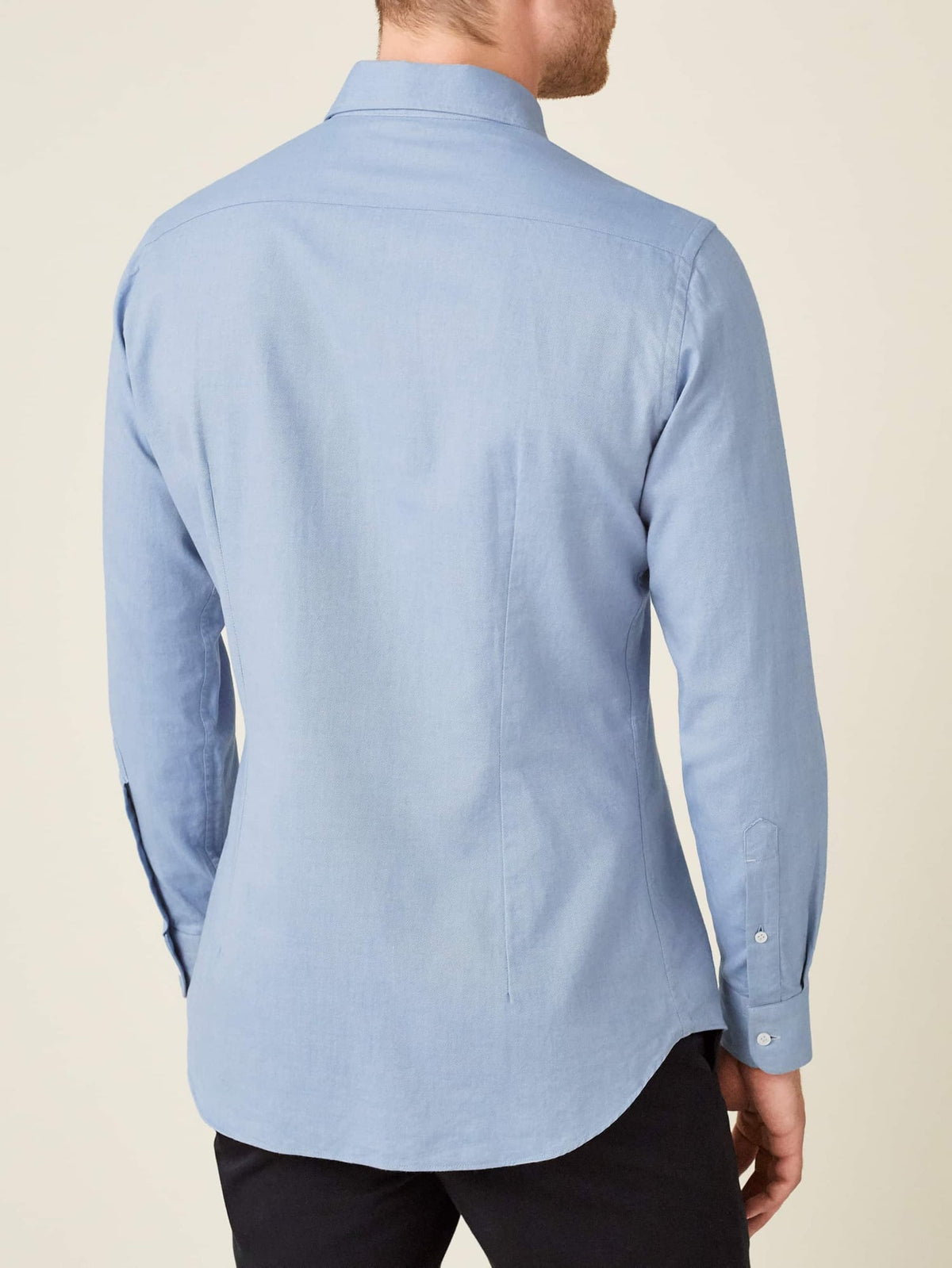 Back view of a model wearing the Luca Faloni Brushed Cotton Shirt in light blue, showing the fit and rounded hem.