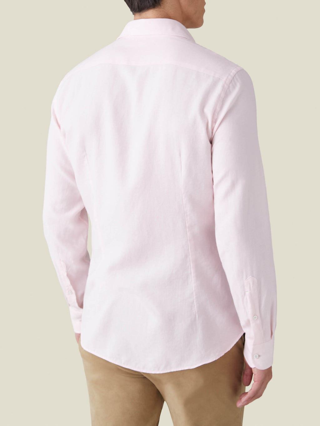 Back view of a man wearing the Luca Faloni Light Pink Cashmere-Cotton Shirt with beige trousers.