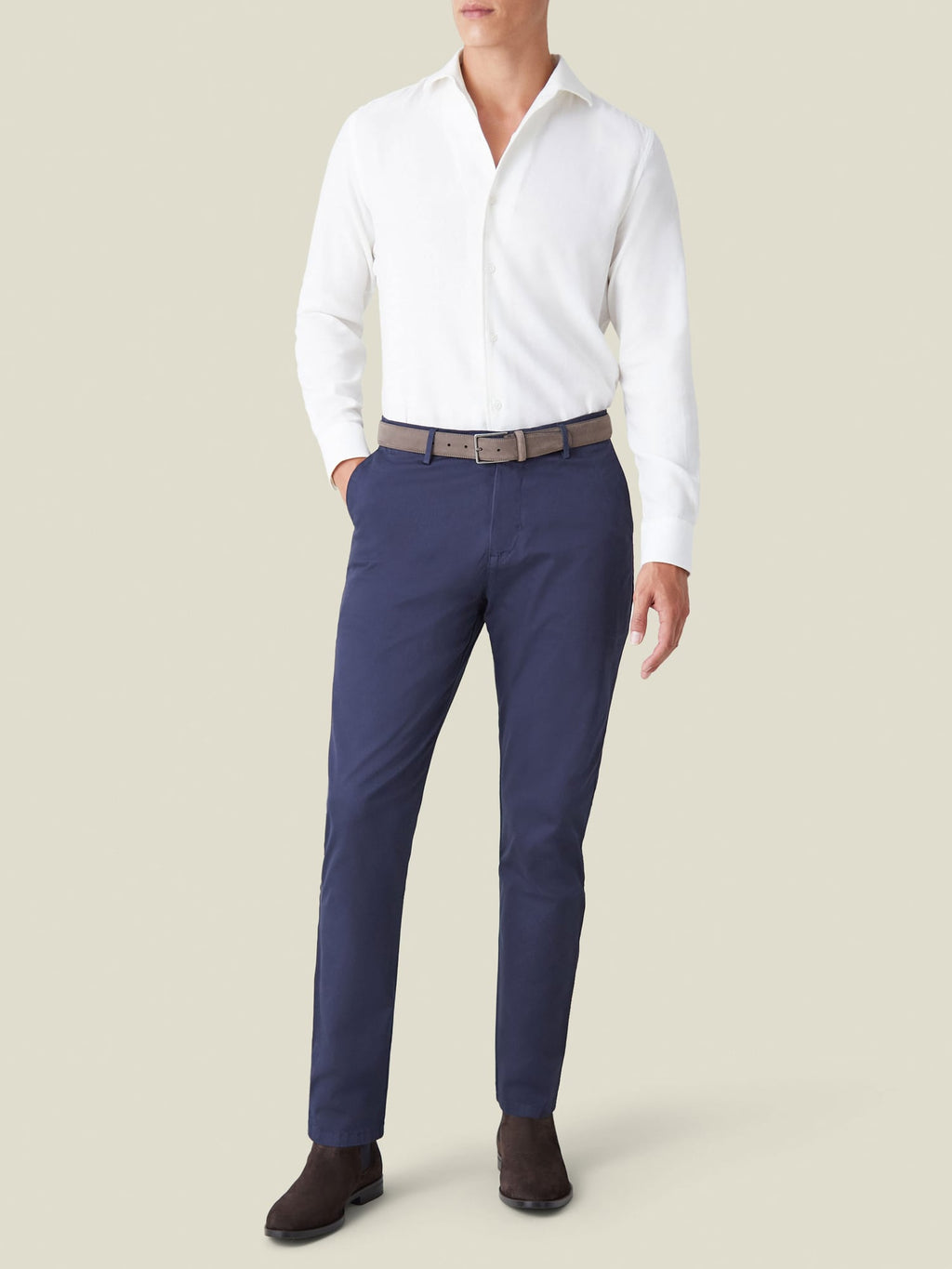 Full-length view of a model wearing the white Cashmere-Cotton Shirt from Luca Faloni with navy chinos and brown boots.