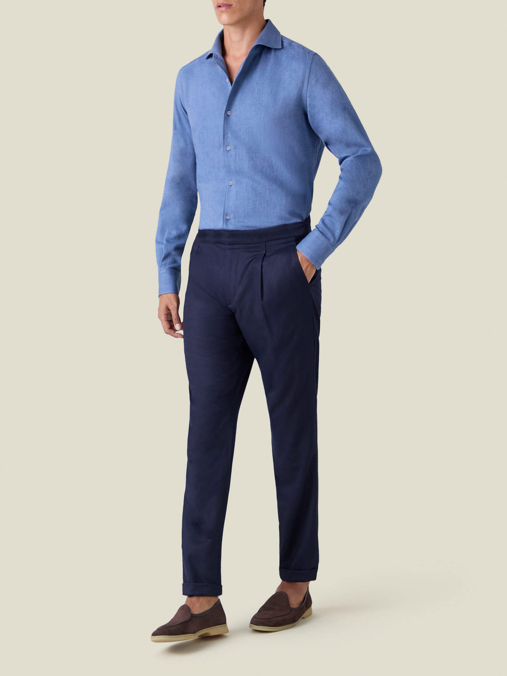 A model wears the Steel Blue Cashmere-Cotton Shirt tucked into navy trousers and paired with brown loafers.