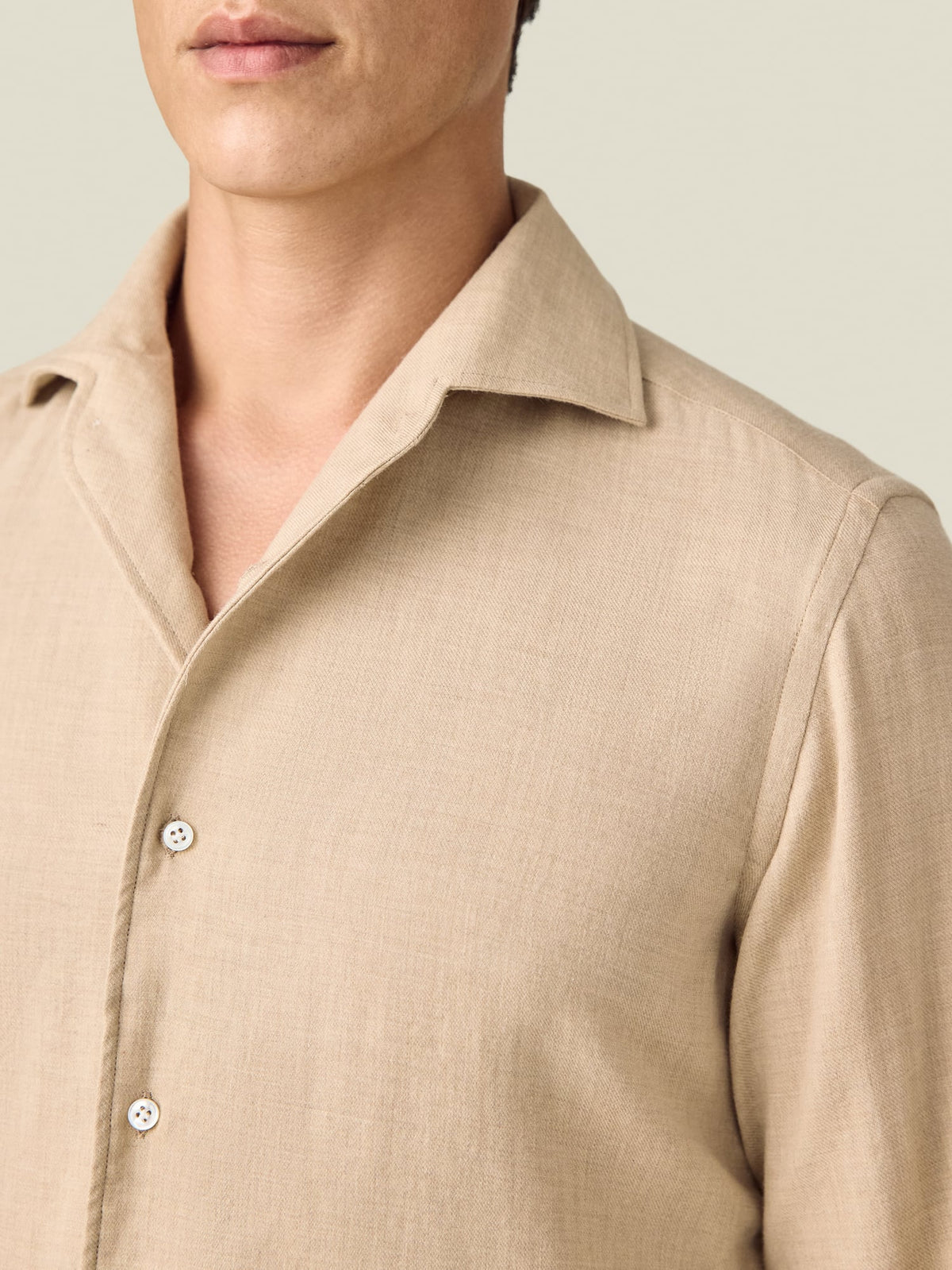 Close-up of a model wearing the Luca Faloni Cashmere-Cotton Shirt in sand, focusing on the collar and fabric texture.