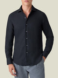A front view of a model wearing the Luca Faloni Black Cashmere-Cotton Shirt with light grey trousers.