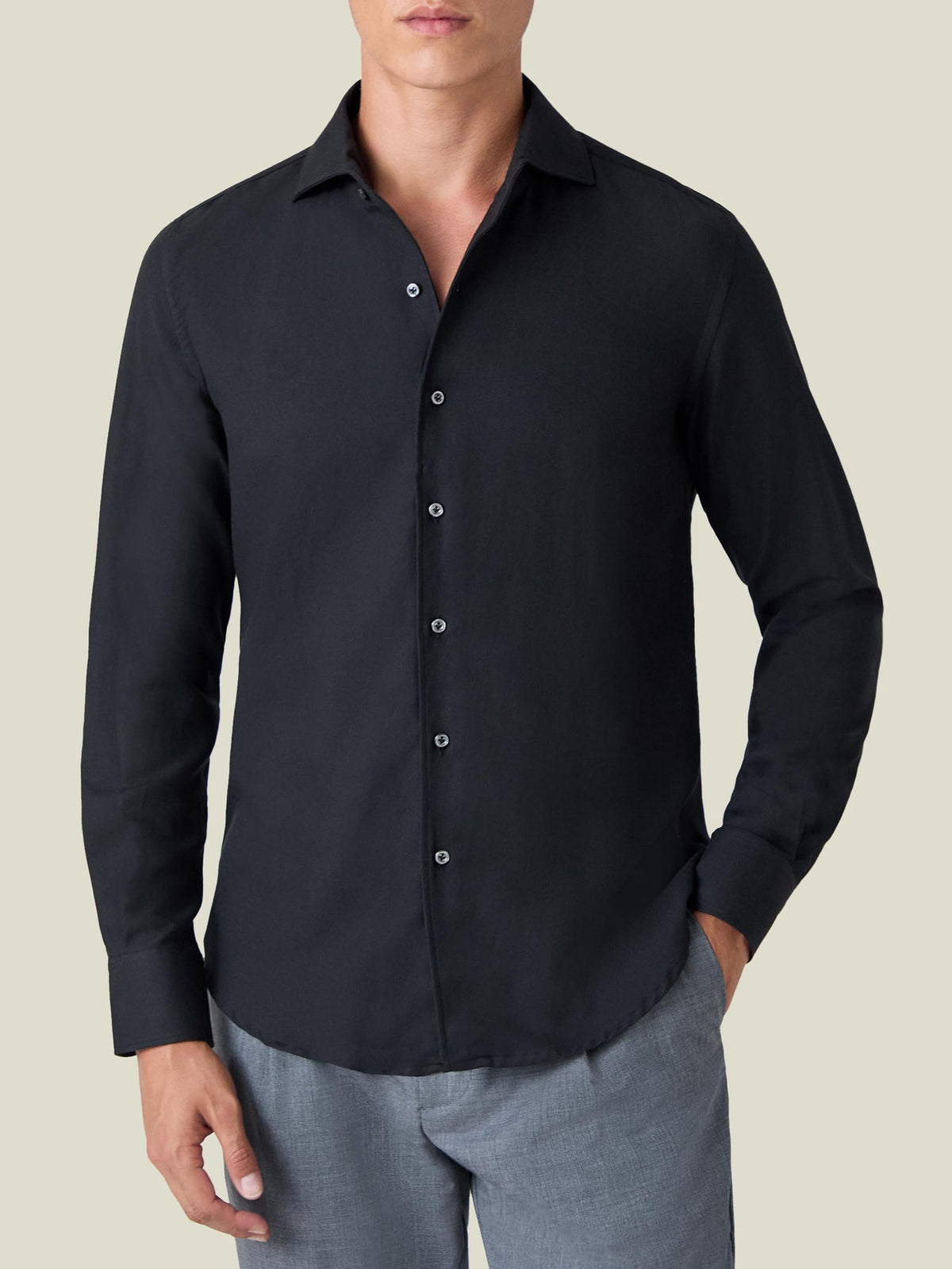 A front view of a model wearing the Luca Faloni Black Cashmere-Cotton Shirt with light grey trousers.