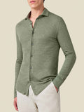 A model wears the Luca Faloni Linen Jersey Shirt in Olive Green, showing its relaxed fit paired with light-coloured trousers.