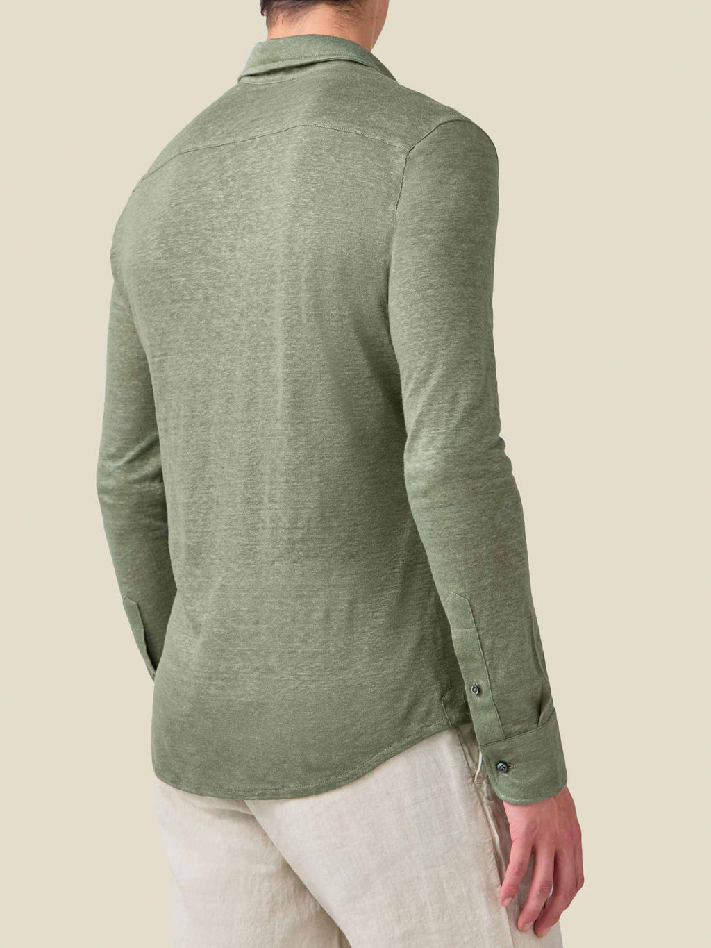 Back view of a man wearing the Olive Green Linen Jersey Shirt, showcasing the relaxed fit and fabric texture.