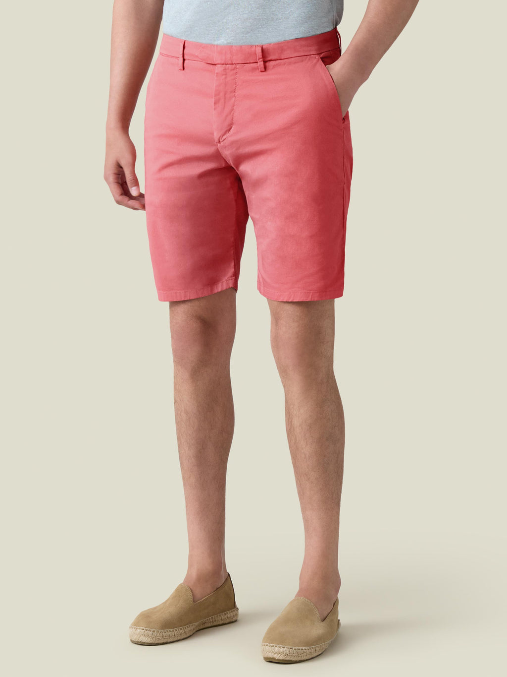 Side view of a model wearing Luca Faloni's Strawberry cotton shorts with a grey t-shirt and tan suede espadrilles.
