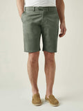 A front view of a model wearing the Luca Faloni Cotton Shorts in Olive Green with a light grey t-shirt and tan loafers.