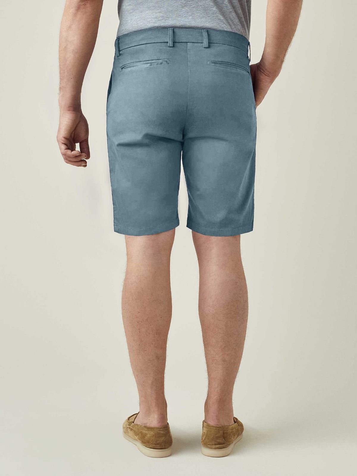 Back view of a model wearing Luca Faloni's light blue Cotton Shorts, showcasing the fit and rear pocket details.
