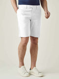 Front view of a model wearing the Luca Faloni White Cotton Shorts with a navy t-shirt and white sneakers.