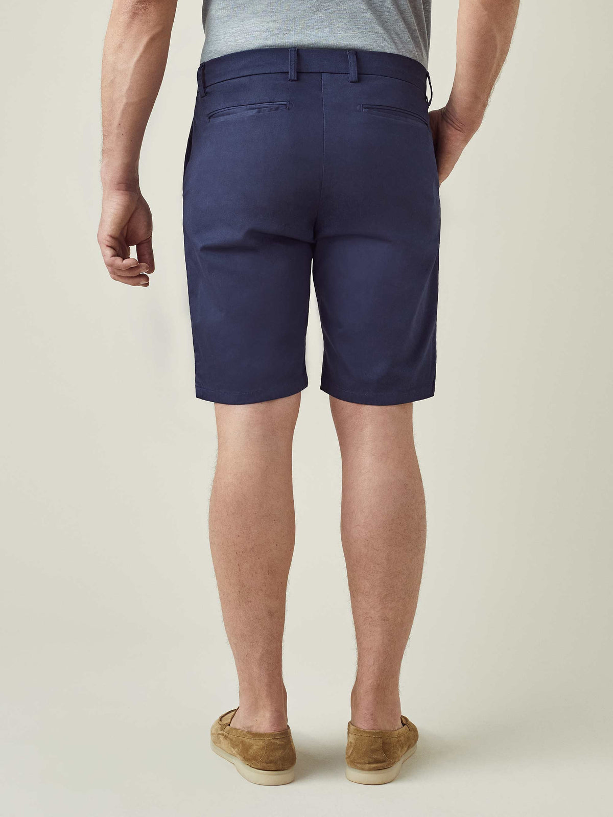Back view of a model wearing Luca Faloni's Navy Blue Cotton Shorts, highlighting the fit and sleek back pocket design.