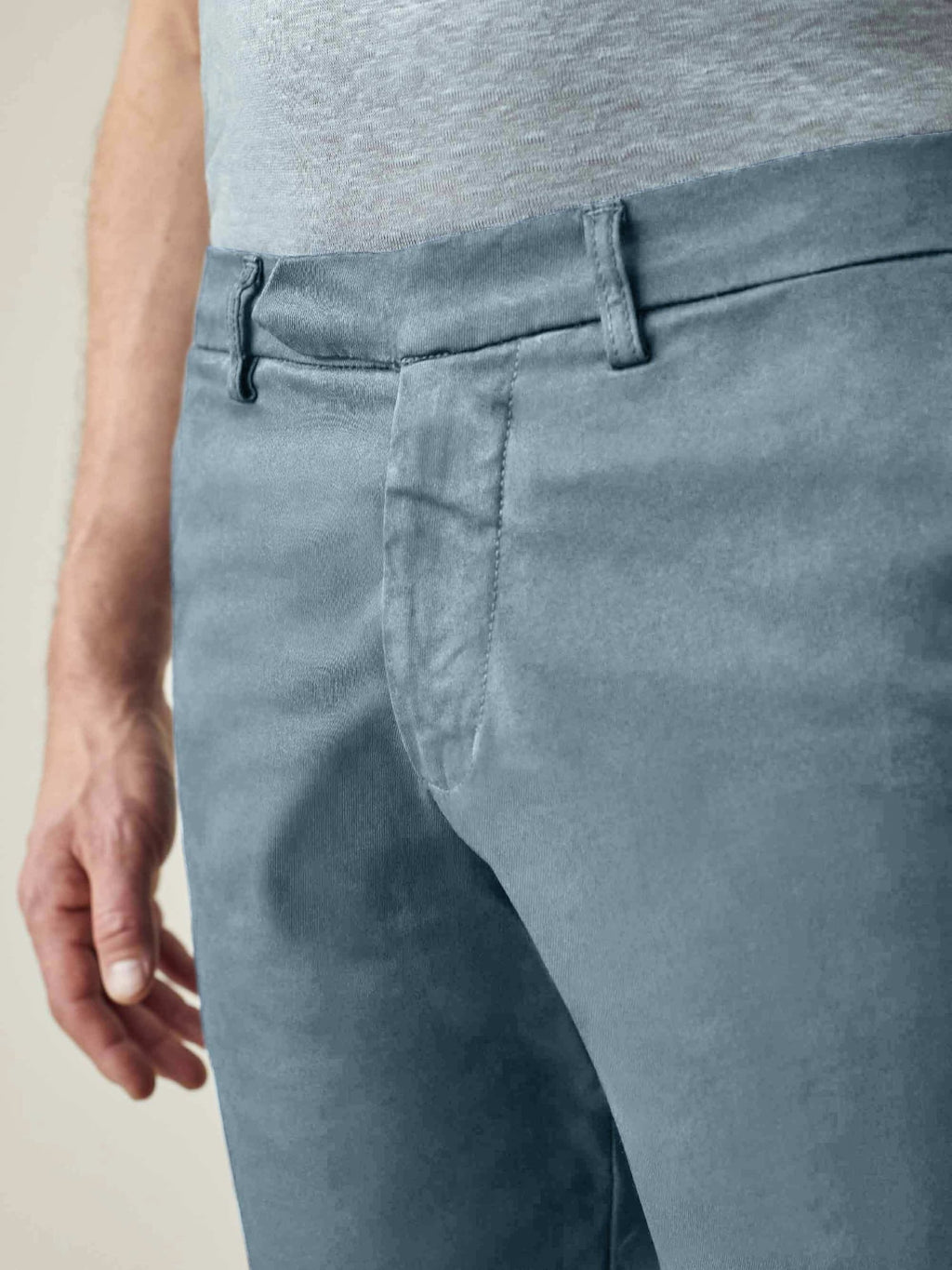 A close-up of a man wearing Luca Faloni's Light Blue Cotton Shorts, showcasing the waistband and concealed button fly.
