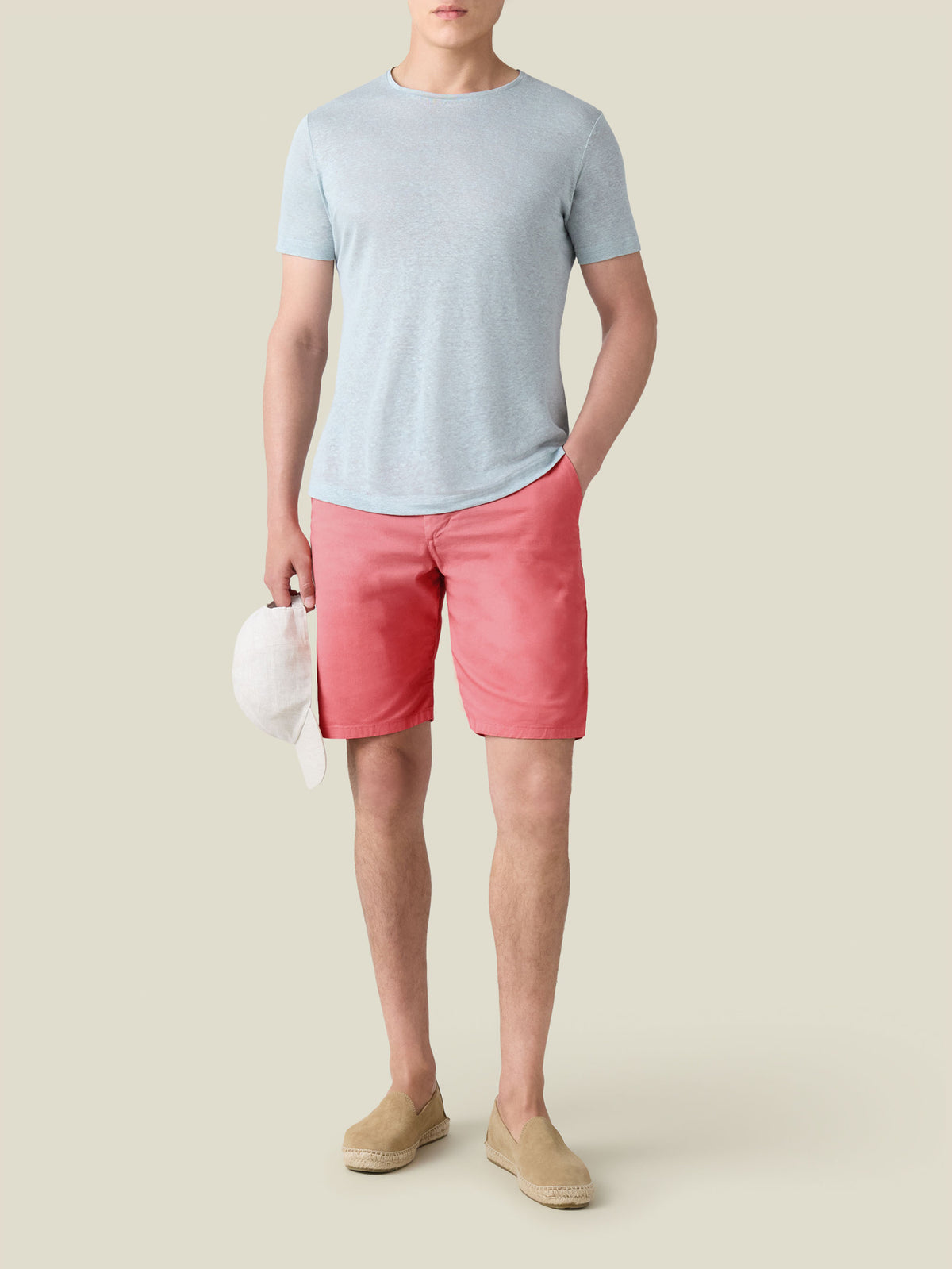 Front view of a model wearing the Luca Faloni Strawberry Cotton Shorts with a light blue t-shirt and beige espadrilles.