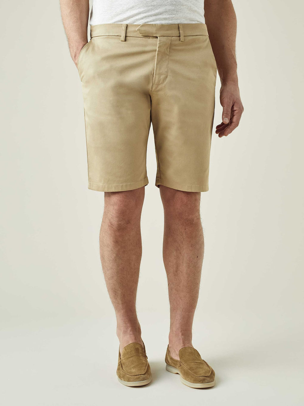 A front view of a model wearing the Luca Faloni Cotton Shorts in Camel Beige with a light grey t-shirt and matching loafers.