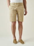 A front view of a model wearing the Luca Faloni Cotton Shorts in Camel Beige with a light grey t-shirt and matching loafers.