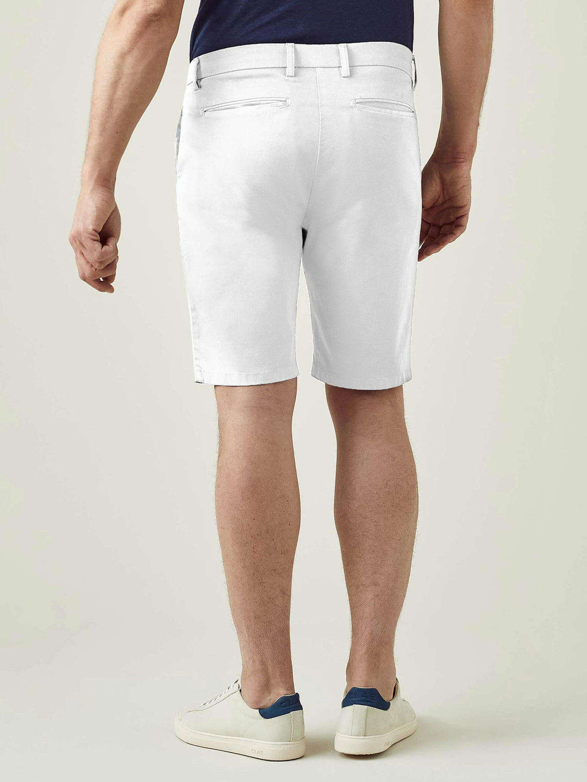 Back view of a man modelling Luca Faloni's white Cotton Shorts, showcasing the slim fit and rear pocket design.