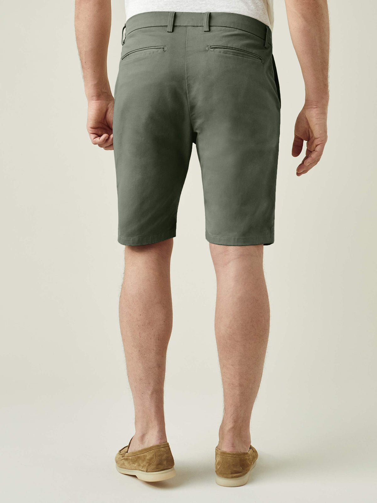Back view of a model wearing Luca Faloni's Olive Green Cotton Shorts, showcasing the slim fit and rear pocket details.