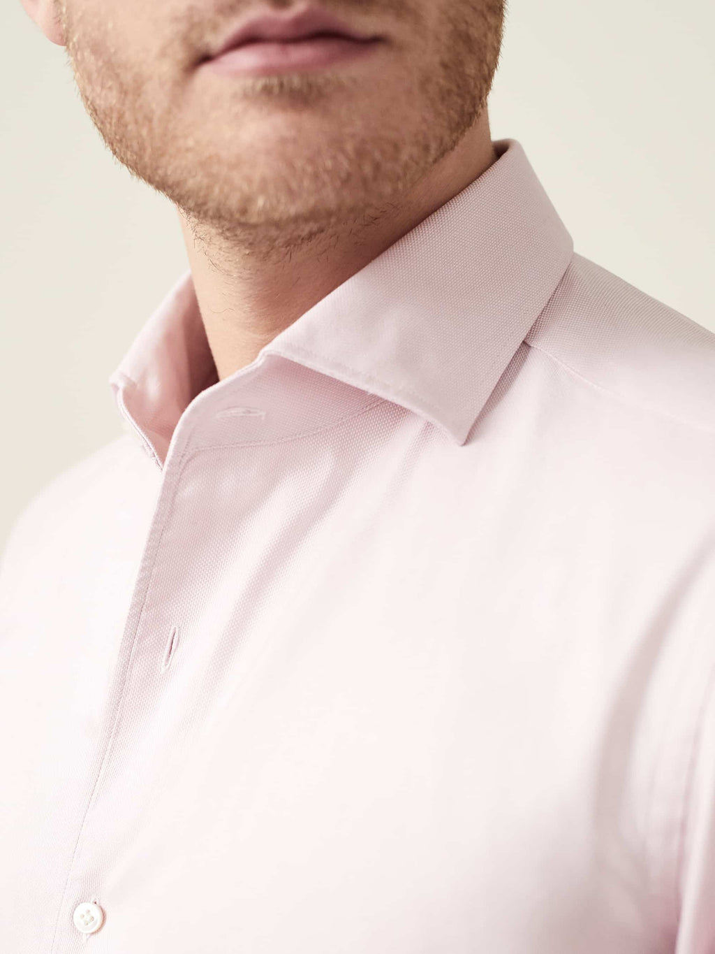 A close-up of the Luca Faloni Light Pink Oxford Cotton Shirt, detailing its one-piece collar and textured weave.