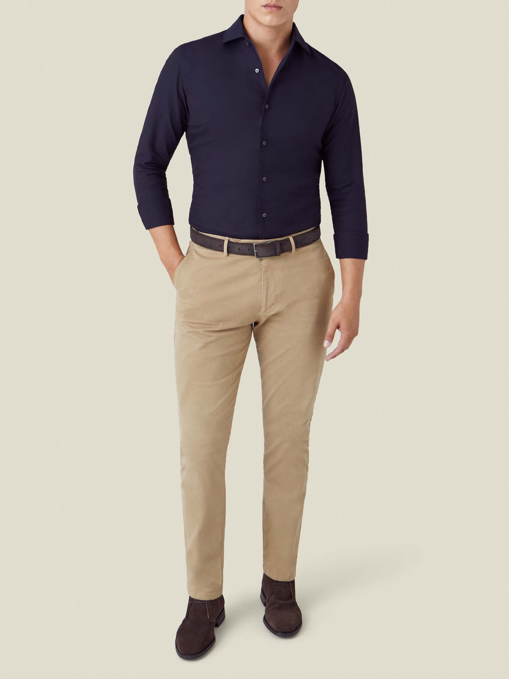 Front view of a model wearing the Midnight Blue Oxford Cotton Shirt, paired with beige trousers and brown suede shoes.
