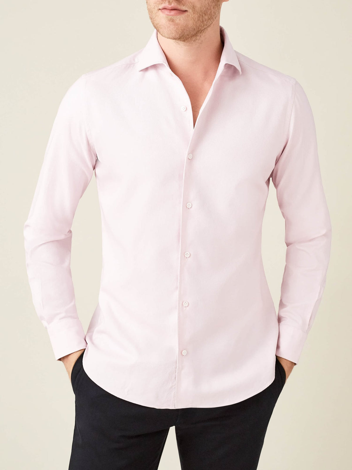 Front view of a model wearing the Luca Faloni Oxford Cotton Shirt in light pink with black trousers.