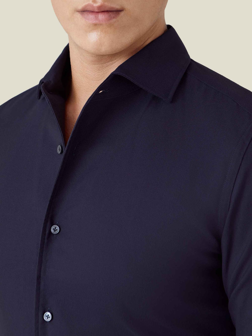 Close-up of Luca Faloni's Oxford Cotton Shirt in midnight blue, showing the signature one-piece collar and fabric texture.