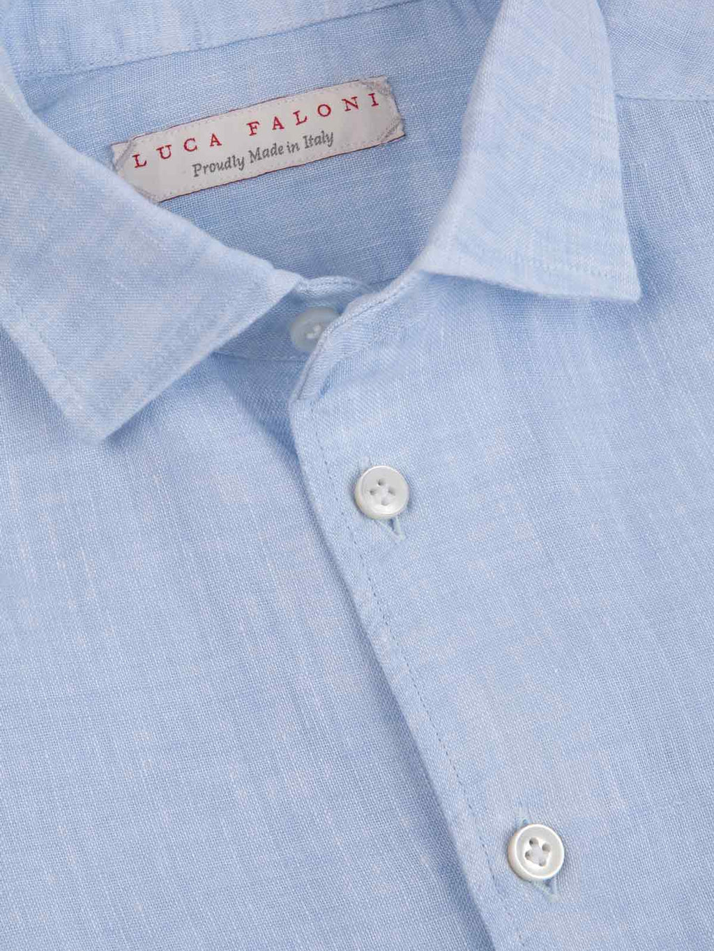 Close-up of the Portofino Junior Linen Shirt in sky blue, detailing the Italian linen, one-piece collar and brand label.