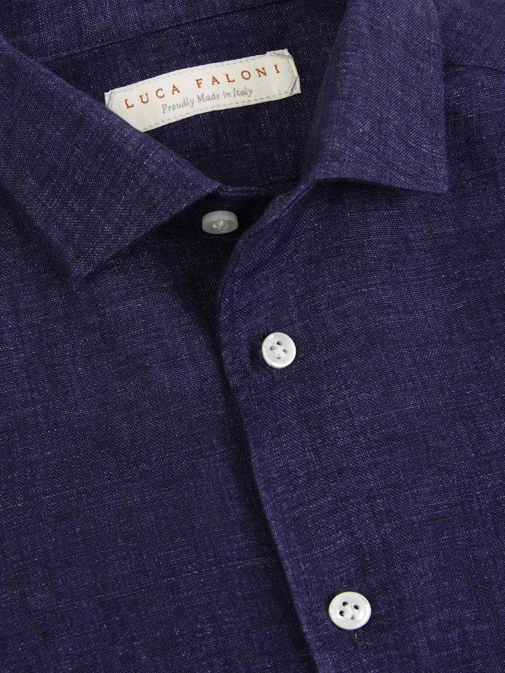 A close-up of the navy blue Portofino Junior Linen Shirt, showing the collar, brand label, and fine linen texture.