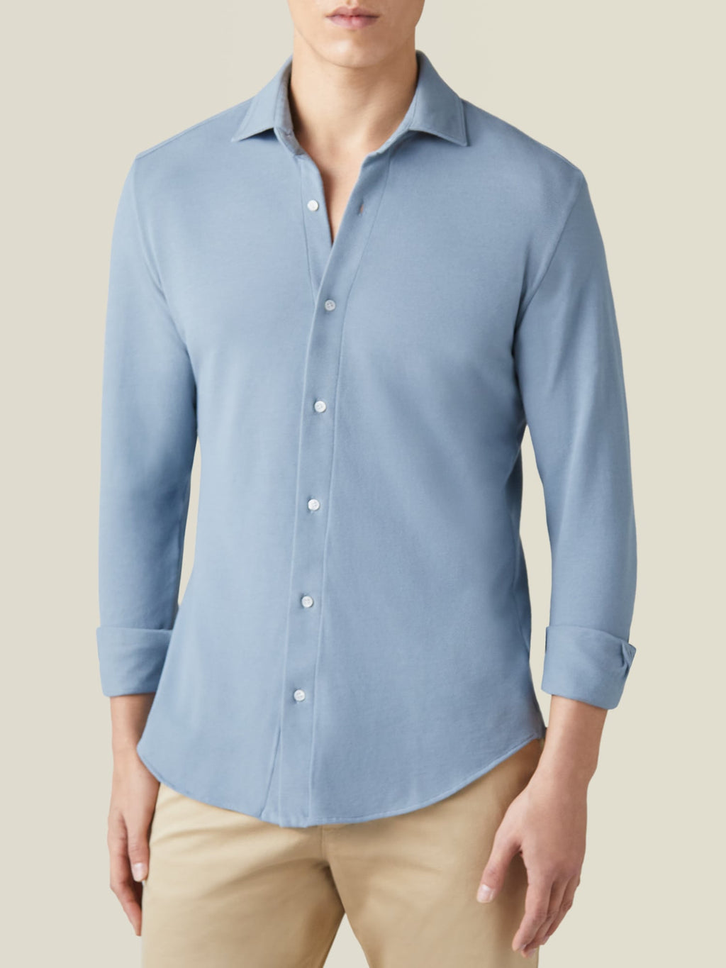 Model wears the French Blue Siena Piqué Shirt with rolled sleeves and beige chinos, highlighting the cutaway collar.