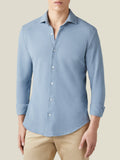 Model wears the French Blue Siena Piqué Shirt with rolled sleeves and beige chinos, highlighting the cutaway collar.
