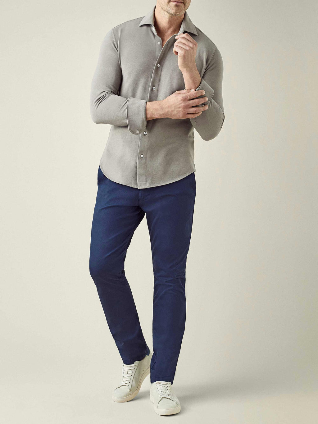 Front view of a model wearing the Luca Faloni Siena Piqué Shirt in Dove Grey, paired with navy trousers.