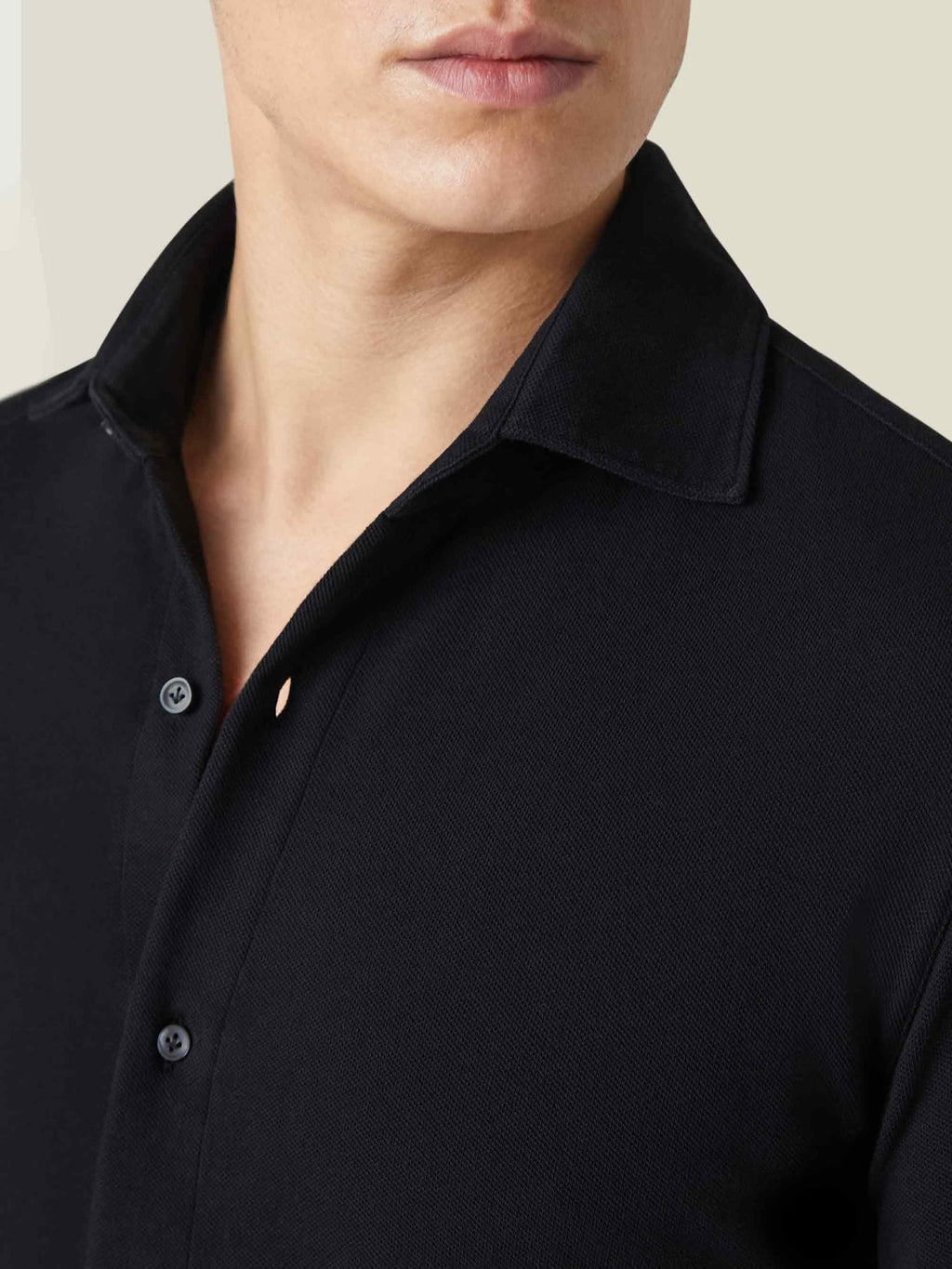 Close-up of the black Siena Piqué Shirt, showing the cutaway collar and distinctive diamond texture of the cotton piqué.