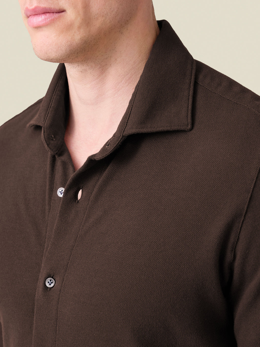 Close-up of a man wearing the Siena Piqué Shirt in Chocolate Brown, detailing the cutaway collar and textured piqué fabric.