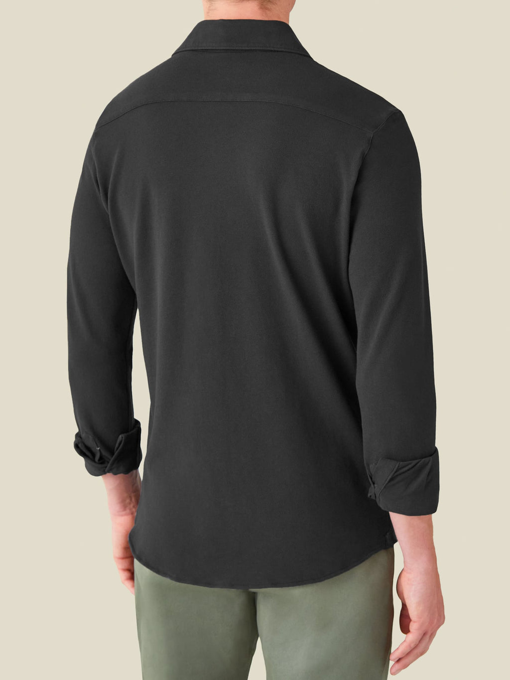 Back view of a model wearing the long-sleeve Siena Piqué Shirt in charcoal grey.