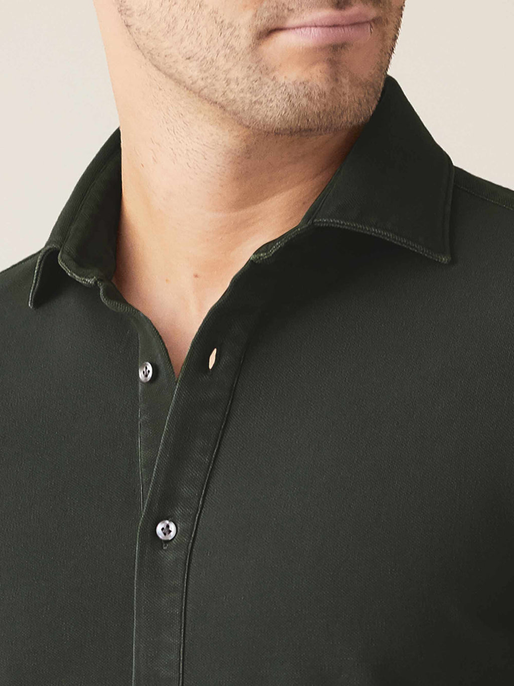 A close-up of the Luca Faloni Siena Piqué Shirt in forest green, detailing the cutaway collar and mother of pearl buttons.
