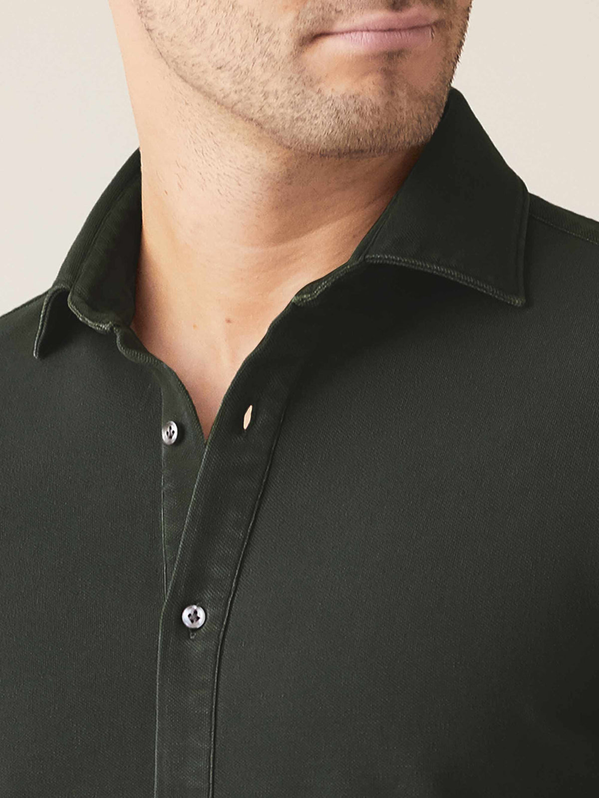 A close-up of the Luca Faloni Siena Piqué Shirt in forest green, detailing the cutaway collar and mother of pearl buttons.