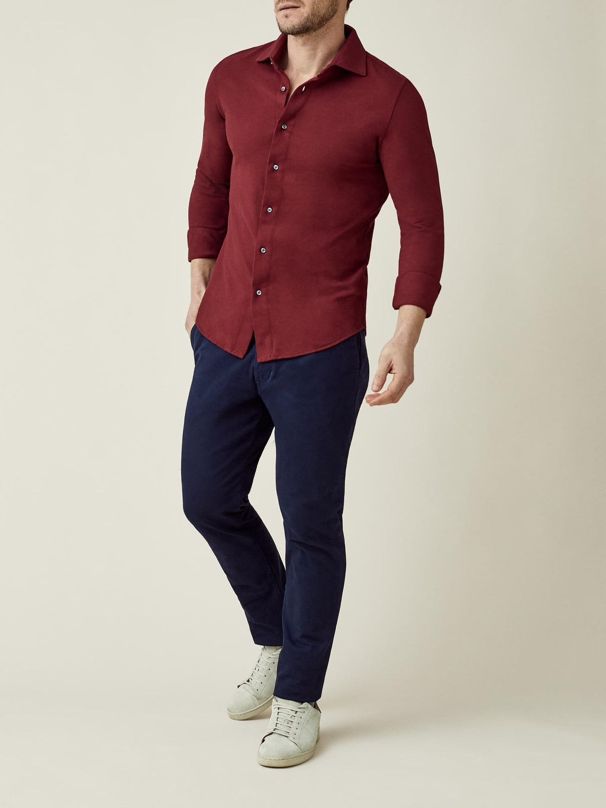 Model wears the Siena Piqué Shirt in Burgundy, styled with navy chinos and white sneakers.