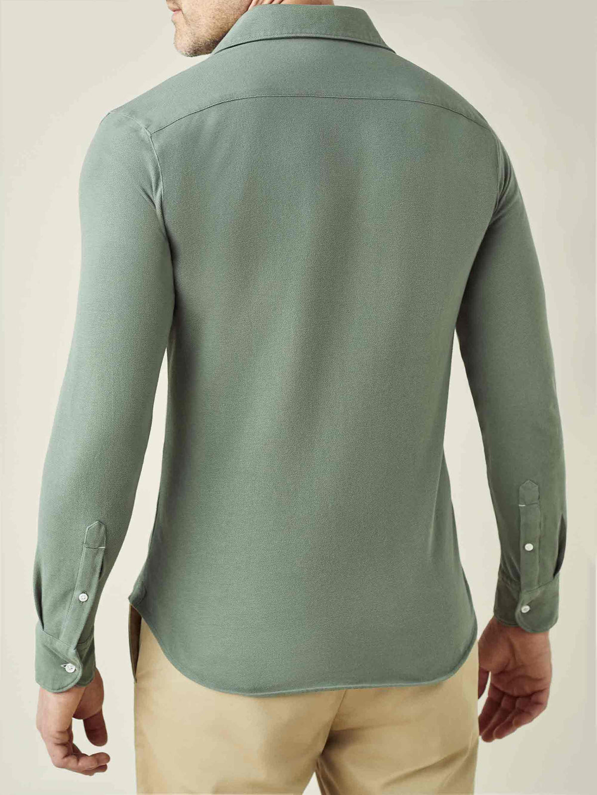 Back view of the Siena Piqué Shirt in Sage Green, worn by a model.