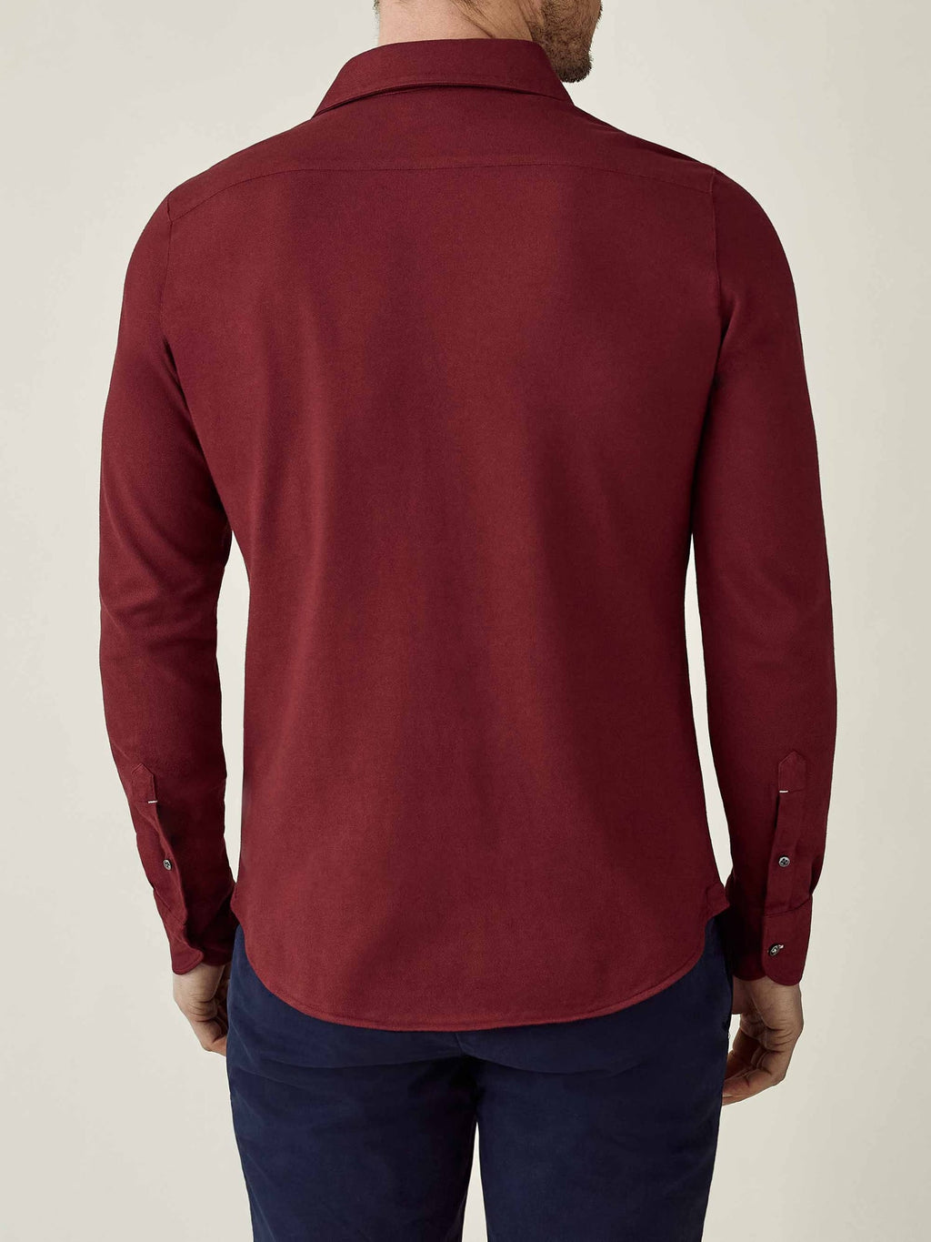 Back view of a model wearing the Siena Piqué Shirt in burgundy.