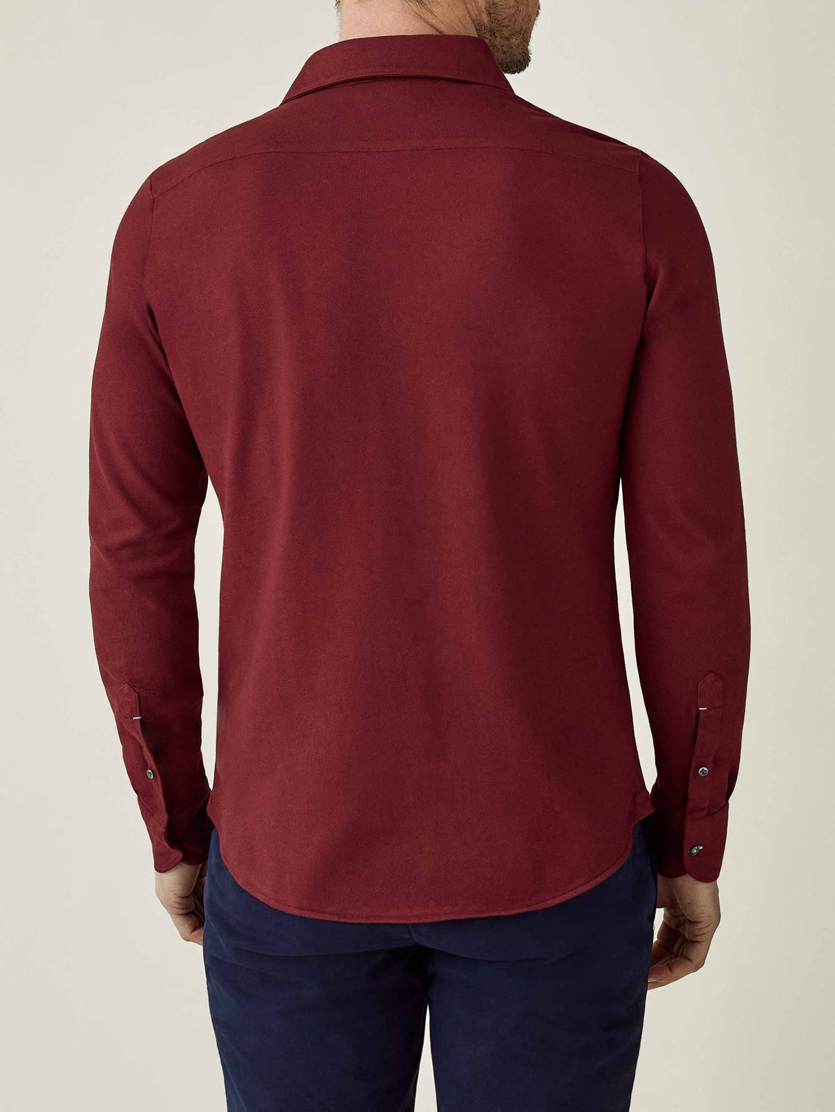 Back view of a model wearing the Siena Piqué Shirt in burgundy.
