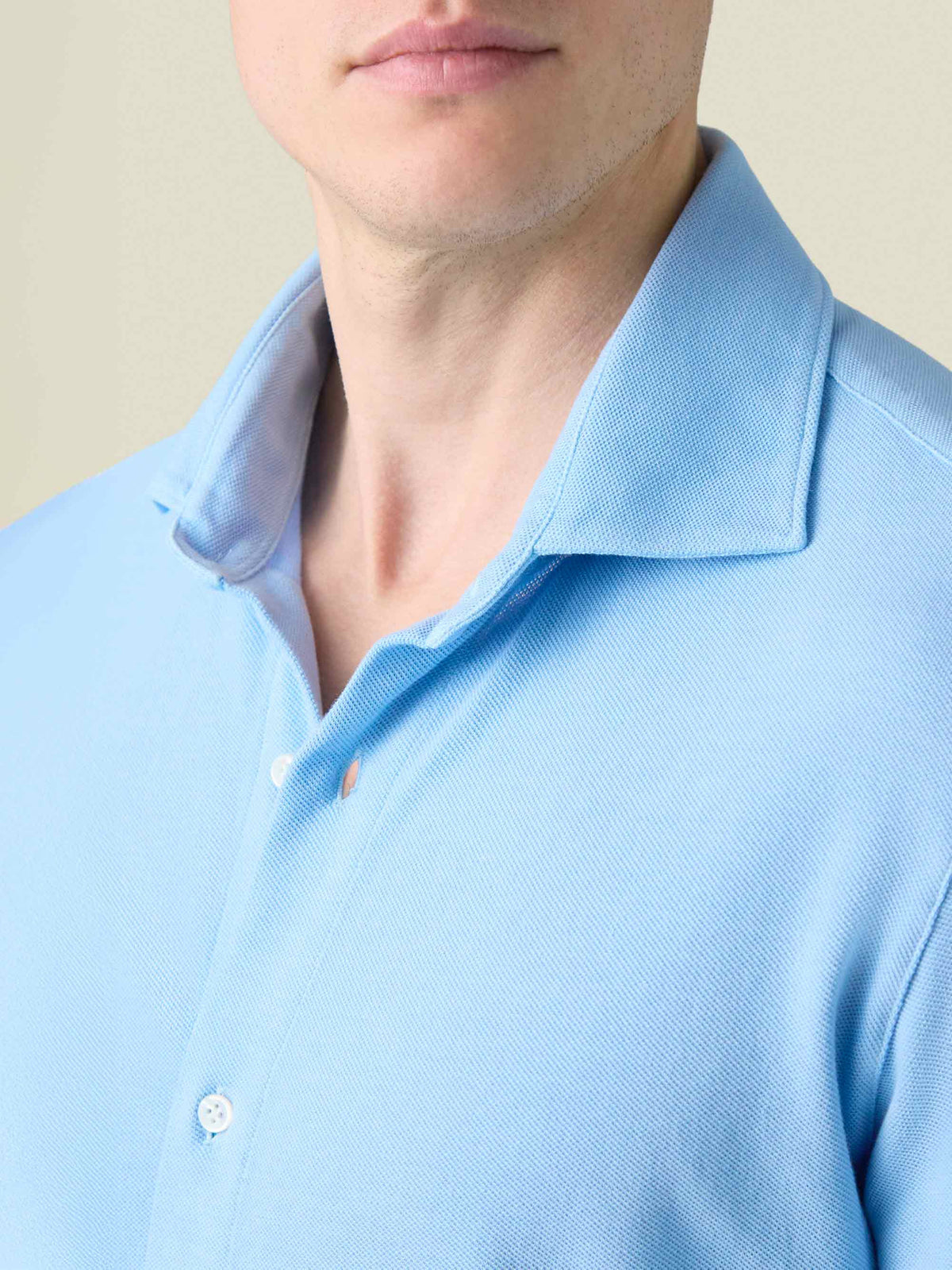 A close-up of the cutaway collar and piqué fabric of the light blue Siena Piqué Shirt.