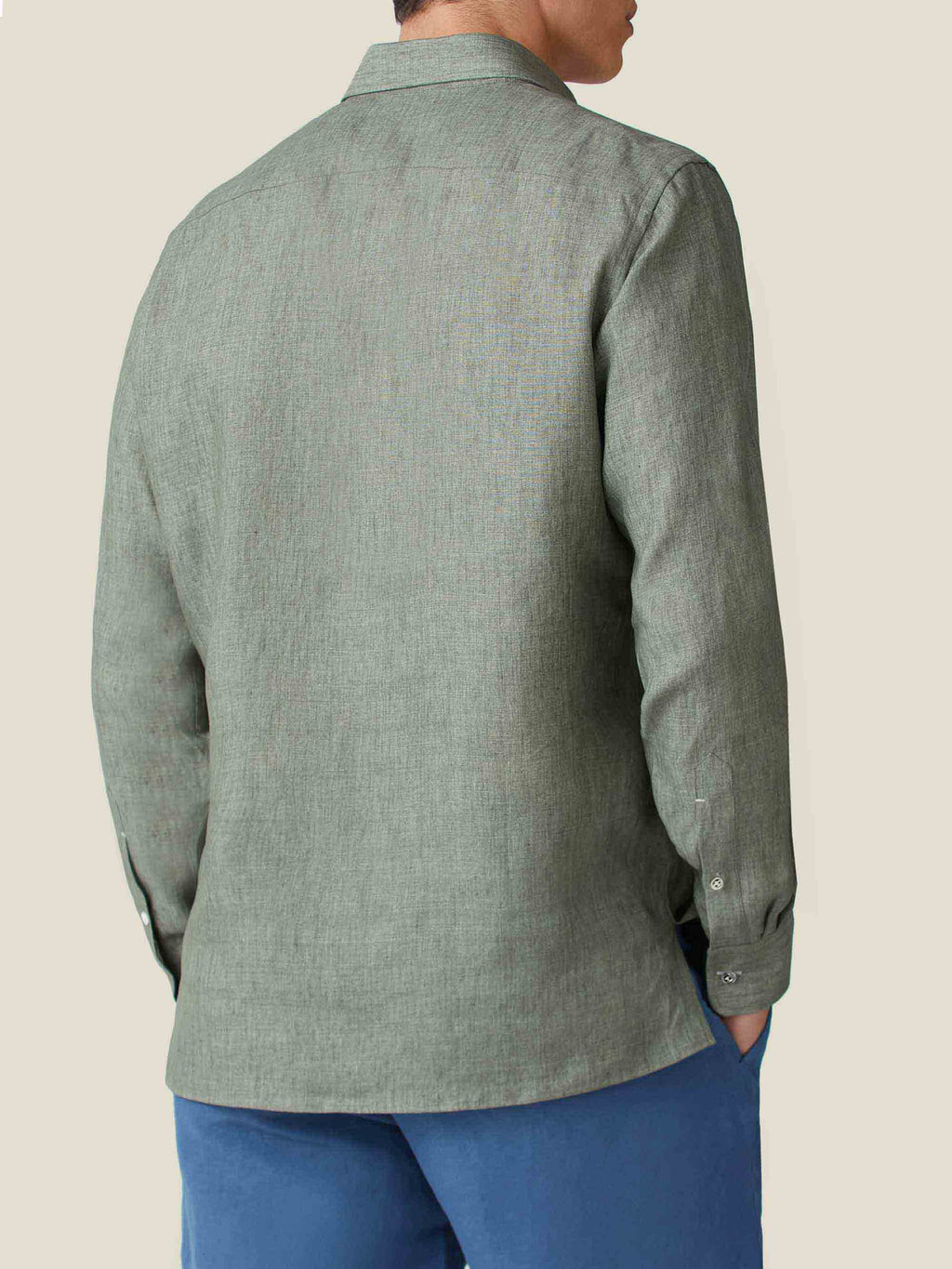 Back of a model wearing the Ravello Linen Shirt in Safari Green, showing its relaxed fit and the texture of the linen.