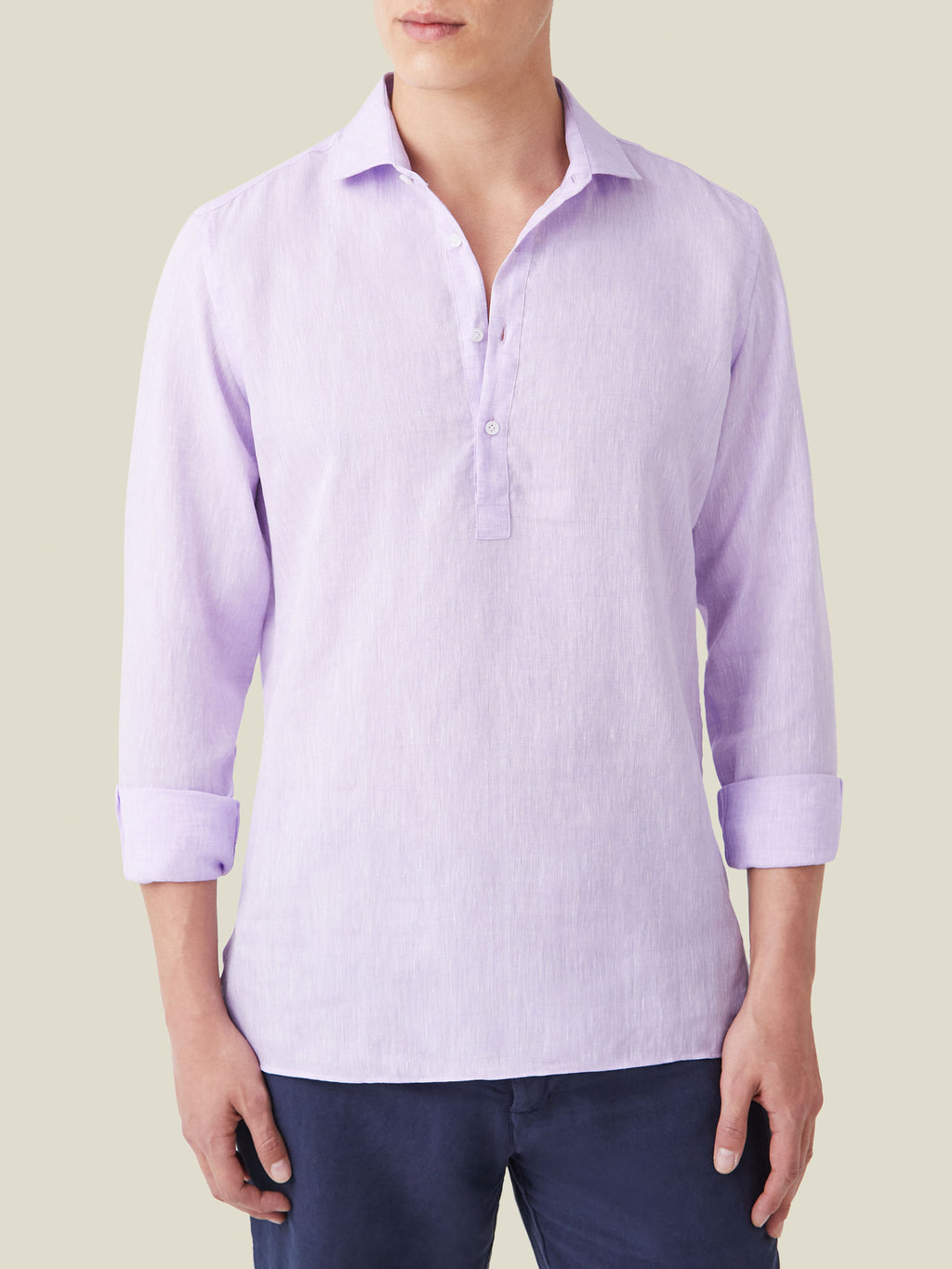 Front view of a model wearing the Ravello Linen Shirt in lilac with rolled-up sleeves.