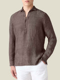 Front view of the Luca Faloni Ravello Linen Shirt in Chocolate Brown on a model, paired with white trousers.
