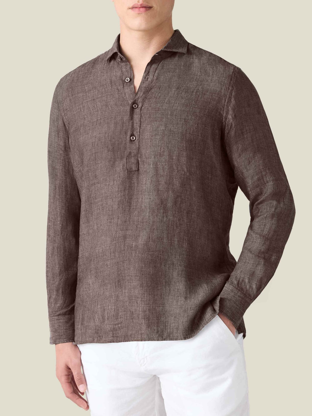 Front view of the Luca Faloni Ravello Linen Shirt in Chocolate Brown on a model, paired with white trousers.