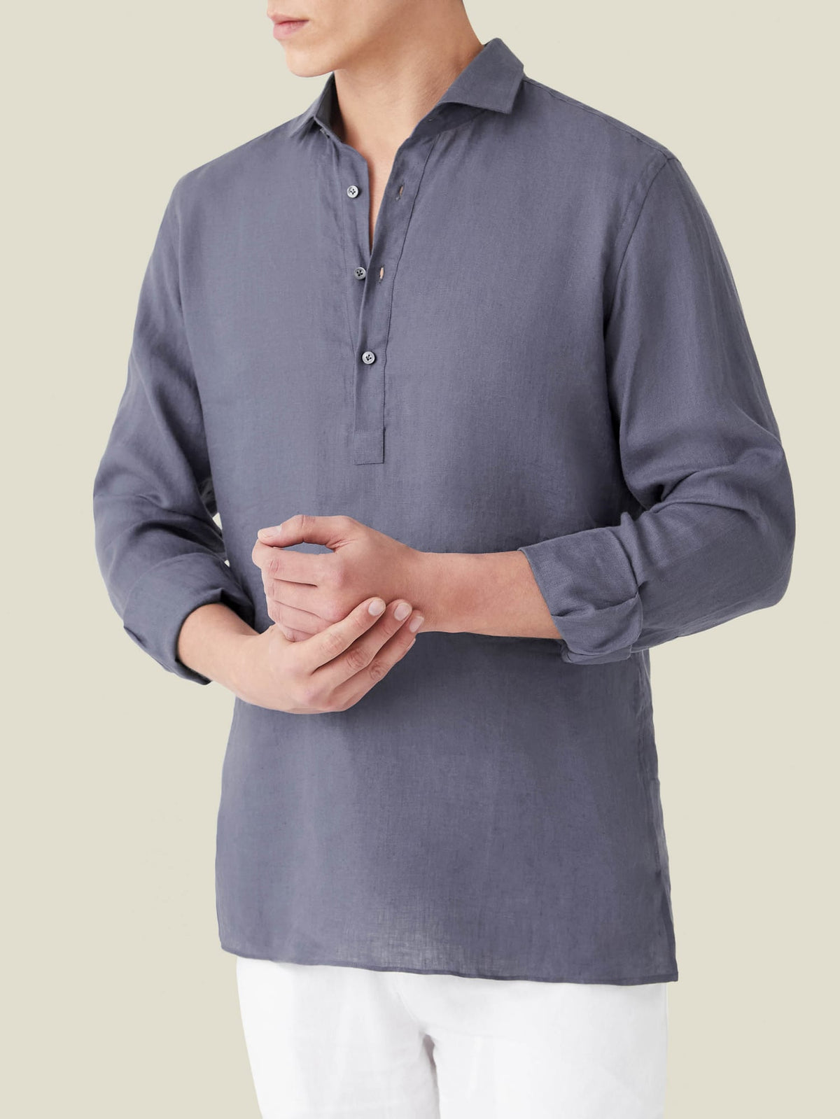 A model wears the Ravello Linen Shirt in Payne's Grey, a long-sleeve popover design with a classic cutaway collar.