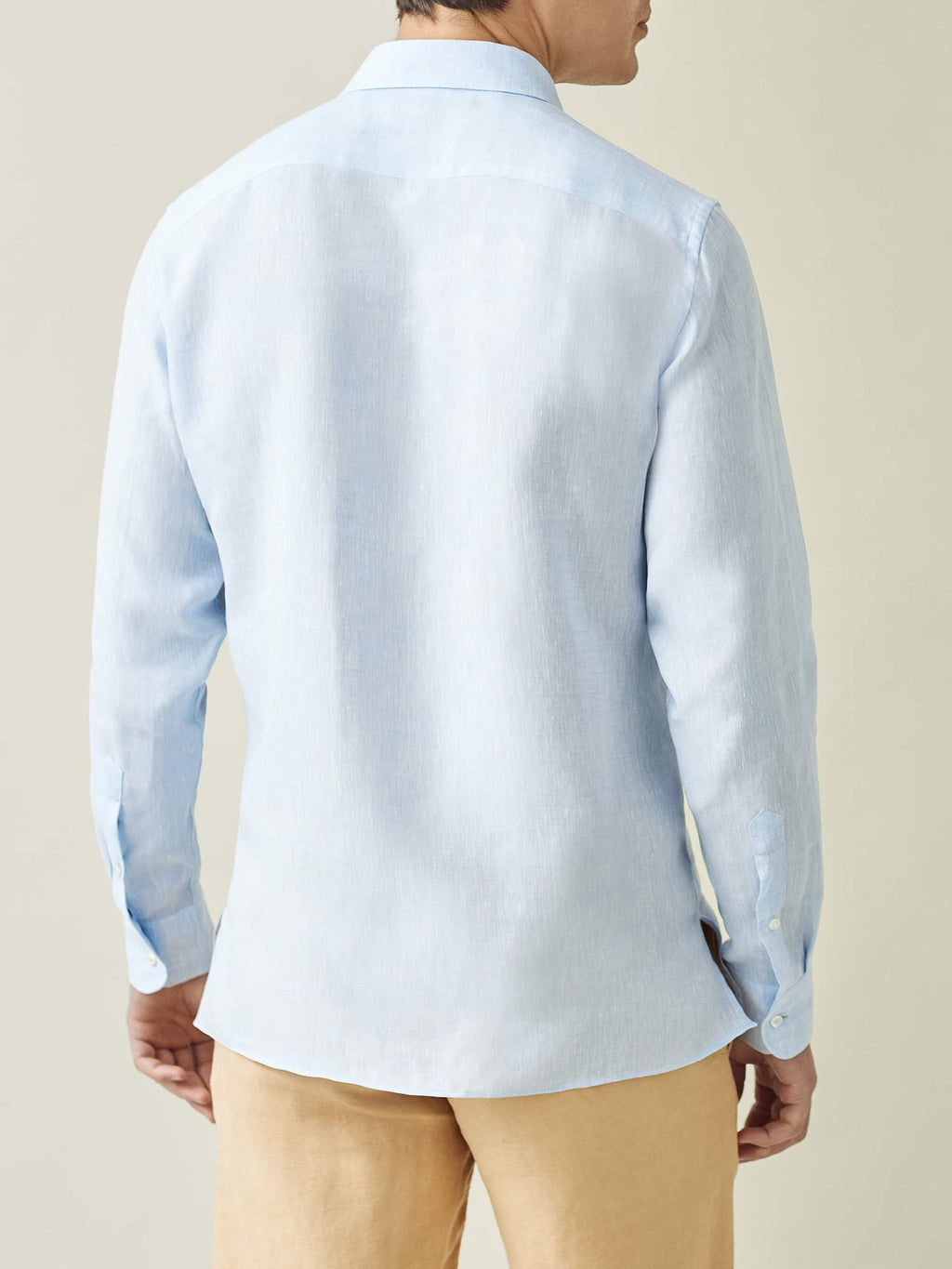 Back of a model wearing the sky blue Ravello linen shirt.