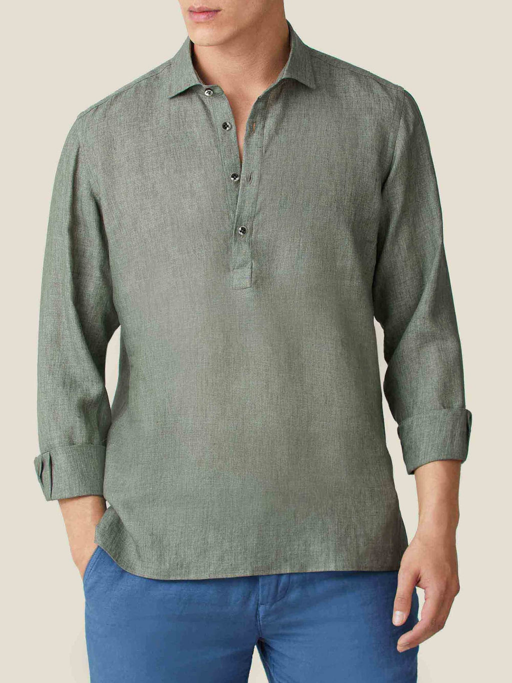 Front view of a model wearing the Ravello Linen Shirt in Safari Green with long sleeves rolled up.
