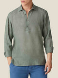Front view of a model wearing the Ravello Linen Shirt in Safari Green with long sleeves rolled up.