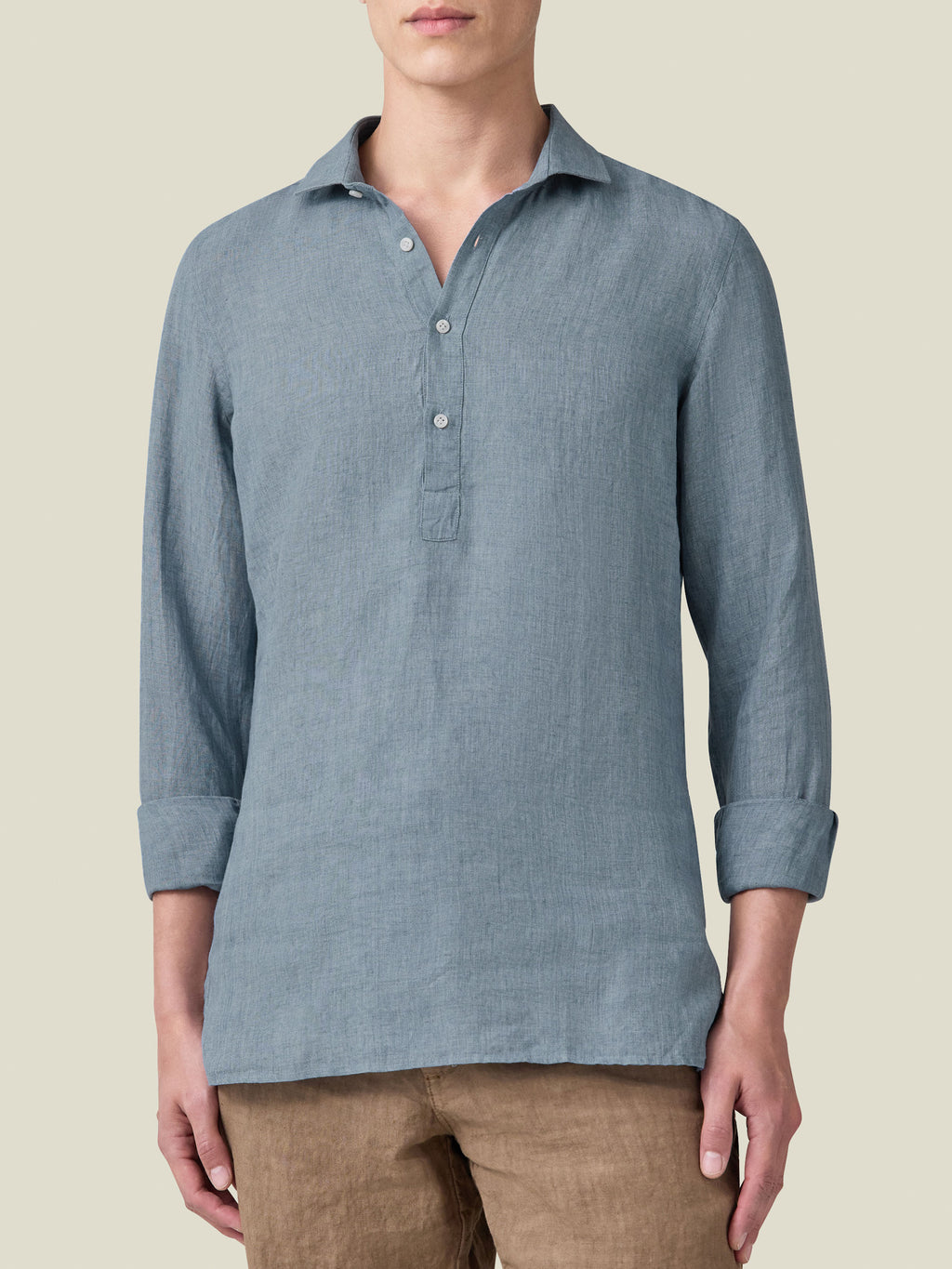 Front view of a model wearing the French Blue Ravello Linen Shirt with sleeves rolled up.