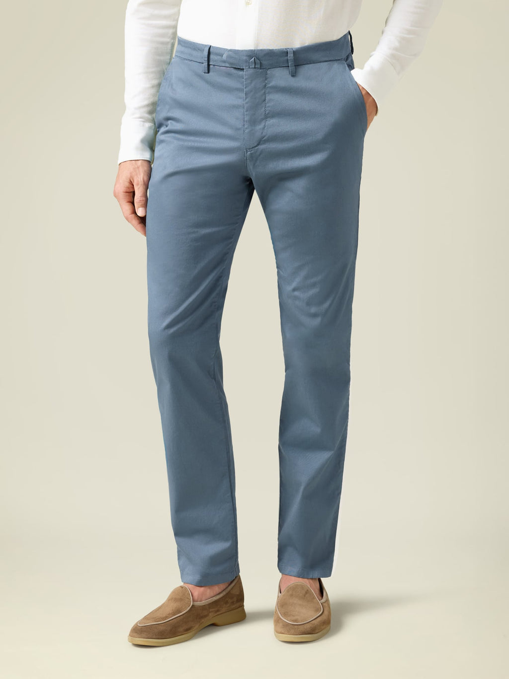 Front view of a model wearing steel blue lightweight cotton chinos, paired with a white shirt and tan suede loafers.