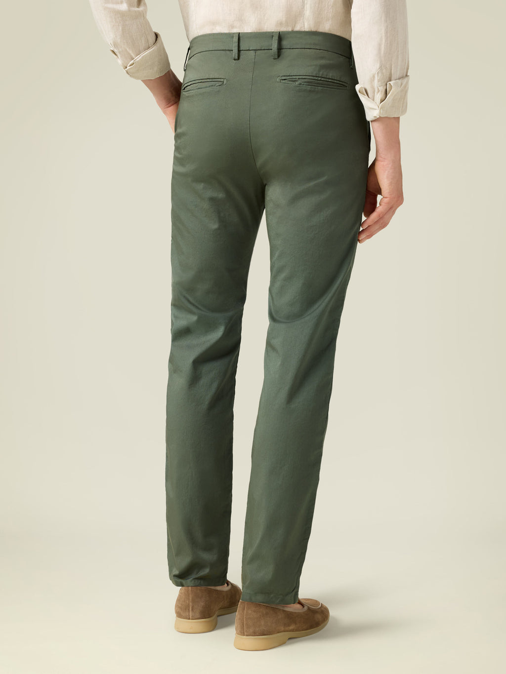 Rear view of a man wearing the Lightweight Cotton Chinos in olive green.